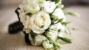 bouquet of white rose on brown surface